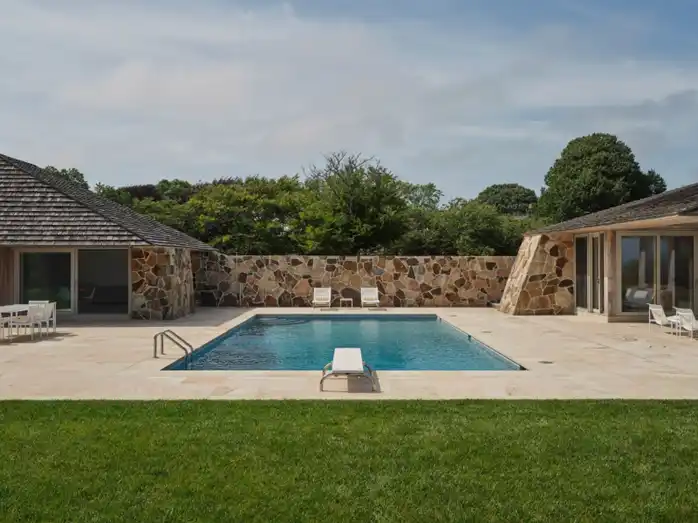 Exterior of Heller Lane showcasing Hamptons-inspired interiors with cedar-shingled roof and sandstone facade.