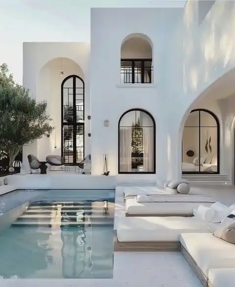 Hamptons resort-style home featuring a luxurious outdoor alfresco dining area with elegant furnishings and seamless indoor-outdoor design.