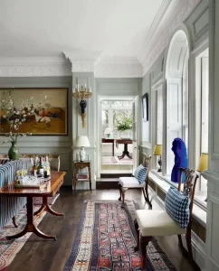 Rug Placement Tips - A cosy living room showcasing a large area rug anchoring the seating arrangement, with all furniture legs resting on the rug.